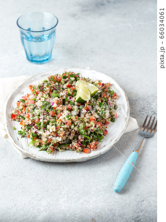 Quinoa Quinua salad with tomatoes and herbs in white bowl 66034061