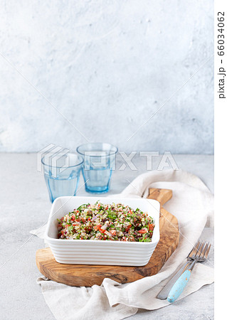 Quinoa Quinua salad with tomatoes and herbs in white bowl 66034062