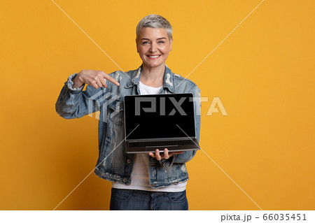 Freelance Websites. Positive Middle-Aged Woman Pointing At Laptop With Black Screen 66035451