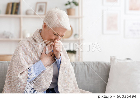 Sick Senior Woman Covered In Blanket Coughing Hard At Home 66035494