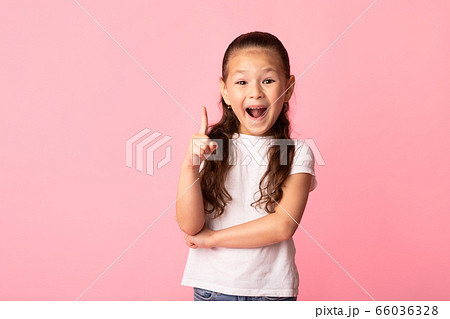 Excited asian girl has great idea and points up 66036328