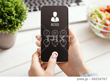 Female Hand Holding Phone With Boss Incoming Call 66036767