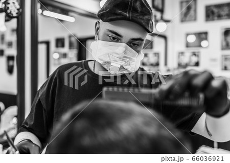 Haircut in quarantine. Haircut in masks from the virus. Hair and health care. 66036921