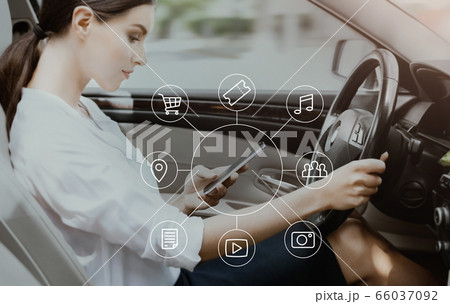Woman Using Voice Search On Phone Driving Sitting In Car 66037092