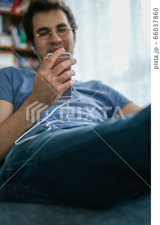 Young man communicating with his friend on a smart Young man communicating with his friend on a smart 66037860