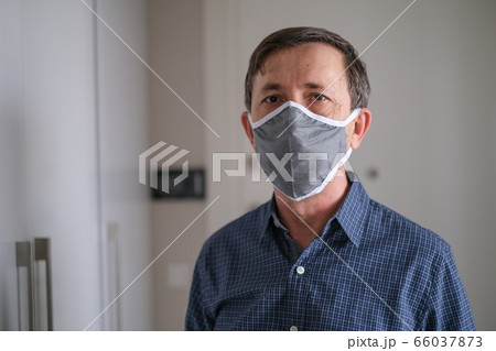 Middle-aged man wears face mask in the Coronavirus Middle-aged man wears face mask in the Coronavirus 66037873