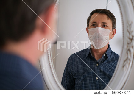Middle-aged man wears hygienic mask Middle-aged man wears hygienic mask 66037874