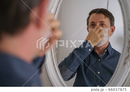 Middle-aged man wears hygienic mask Middle-aged man wears hygienic mask 66037875