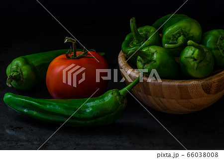 chili pepper and tomato on dark background chili pepper and tomato on dark background 66038008