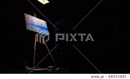 Artist copyist paint seascape with ship in ocean. Craftsman decorator draw as boat sail on blue sea. Black background. Wide angle shot. 66043885