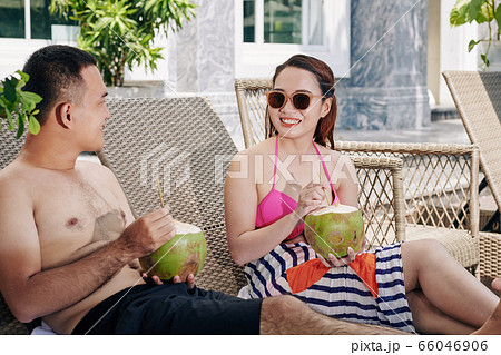 Couple resting in chaise-lounges Couple resting in chaise-lounges 66046906