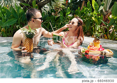 Joyful couple in swimming pool Joyful couple in swimming pool 66046930