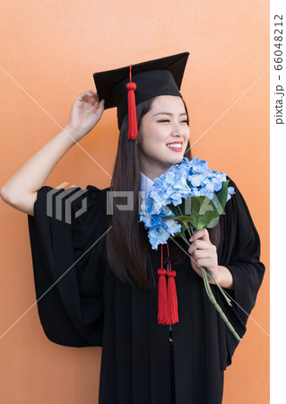 Asian graduate woman in cap gown on isolated Asian graduate woman in cap gown on isolated 66048212
