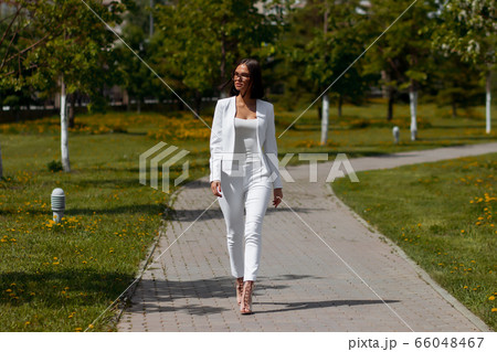 Young carefree female in glasses and trendy outfit Young carefree female in glasses and trendy outfit 66048467