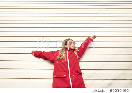 Girl with sunglasses and red jacket 66050490