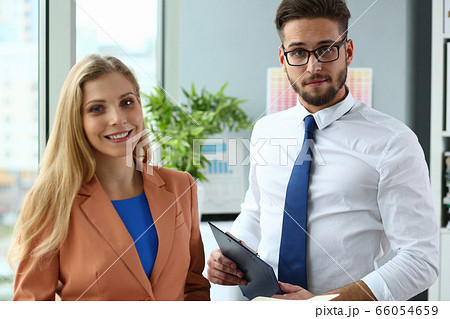 Two delighted colleagues preparing for business conference 66054659