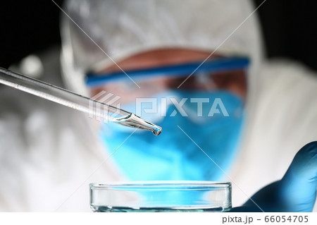 Focused photo on pipette that dropping liquid Focused photo on pipette that dropping liquid 66054705