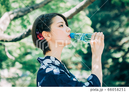 ラムネを飲む浴衣の女性の写真素材