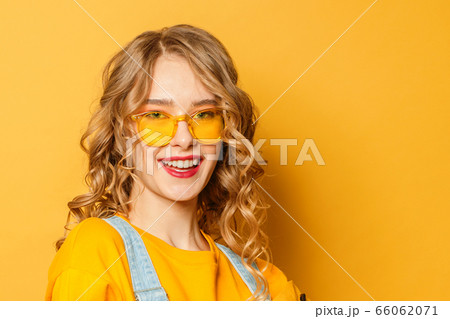 Happy smiling woman in sunglasses on vibrant Happy smiling woman in sunglasses on vibrant 66062071