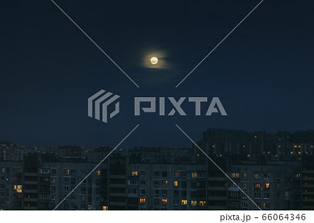 Night-time cityscape with full-moon in the sky. Night-time cityscape with full-moon in the sky. 66064346