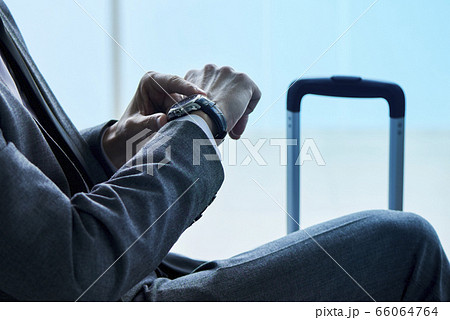 businessman watching his watch at the airport 66064764