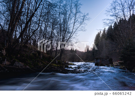 Old foundation of a ruined mill in a fast flowing river in a spring landscape 66065242