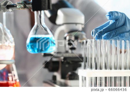 Close up of scientist that working with test tubes Close up of scientist that working with test tubes 66066436