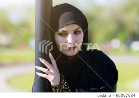 Sad woman in muslim clothes. Sad woman in muslim clothes. 66067034
