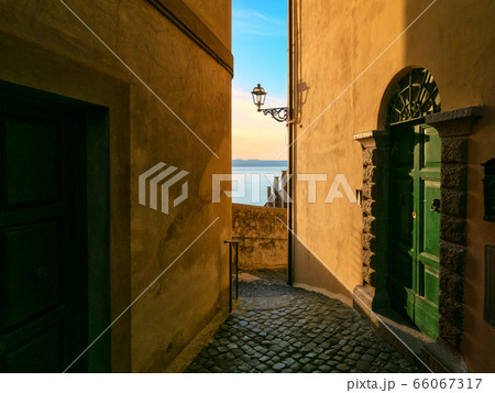 Old town street on evening in Italy 66067317