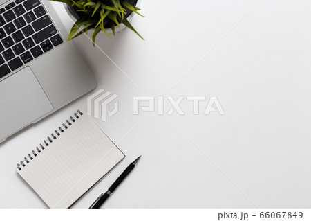 Top view office desk with notebook computer and office supplies on white background 66067849