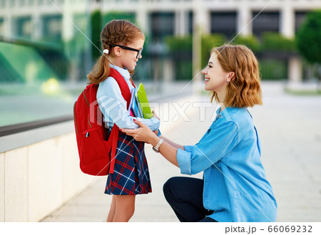 first day at school. mother leads little child first day at school. mother leads little child 66069232