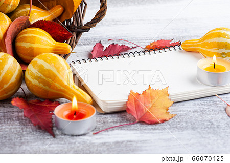 Small decorative pumpkins with lit candles Small decorative pumpkins with lit candles 66070425