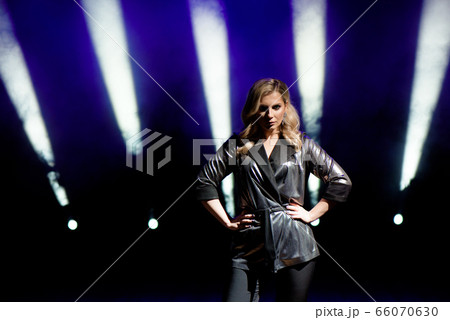 Young woman with colorful lights on concert on the 66070630