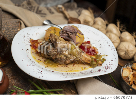 delicious meat meal with garlic, tomato on the table 66070773