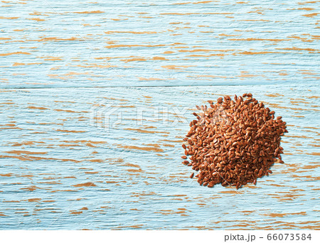 flax seeds on a blue wooden background, top view. flax seeds on a blue wooden background, top view. 66073584