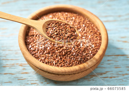 flax seed in a wooden bowl on a rustic table, flax seed in a wooden bowl on a rustic table, 66073585