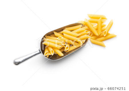 Uncooked penne pasta in scoop. Dried italian pasta Uncooked penne pasta in scoop. Dried italian pasta 66074251