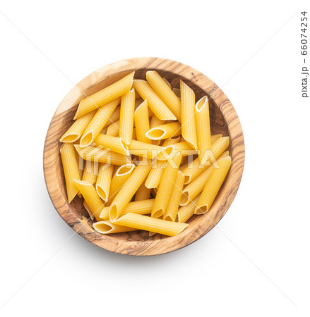 Uncooked penne pasta in bowl. Dried italian pasta 66074254