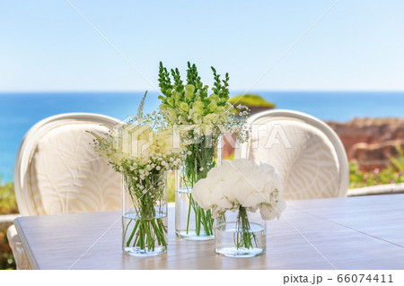 Beautiful wedding bouquet on a table by the ocean, on the beach. 66074411