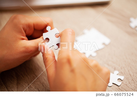 Business success concept, woman makes up puzzle Business success concept, woman makes up puzzle 66075524