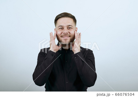 Happy Male Smiles, Touches Fingers To His Face. The Concept Of Tenderness. Happy Male Smiles, Touches Fingers To His Face. The Concept Of Tenderness. 66076504