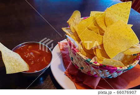 A bowl of Mexican corn chips with salsa 66076907