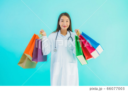 Portrait beautiful young asian doctor woman with colorful shopping bag 66077003