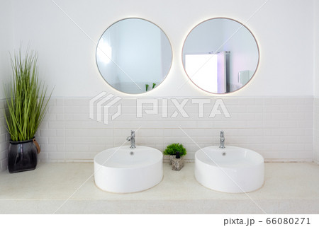 Modern public bathroom with white basin and circle Modern public bathroom with white basin and circle 66080271