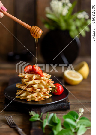 Delicious fresh baked belgian waffles with berries Delicious fresh baked belgian waffles with berries 66082000