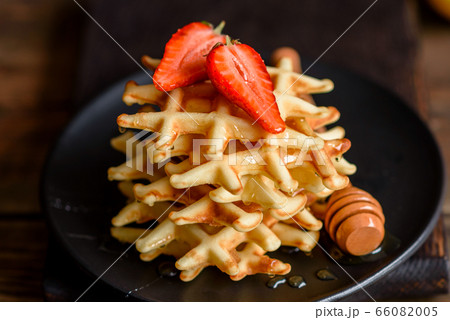 Delicious fresh baked belgian waffles with berries Delicious fresh baked belgian waffles with berries 66082005