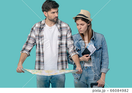 Young man with map girl with tickets and suitcase. Young man with map girl with tickets and suitcase. 66084982