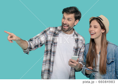 Man pointing finger to the side and girl in hat Man pointing finger to the side and girl in hat 66084983
