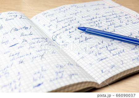 Children's hand with a brush for painting draws a picture with watercolor paints. 66090037