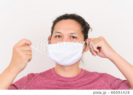 Portrait of Asian man wearing white fabric mask to protection corona virus outbreak and pollution 66091428